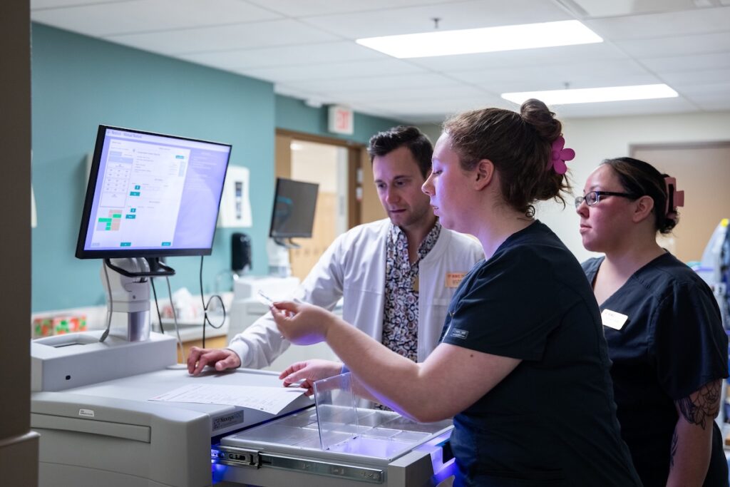 Nursing students receive instruction on healthcare technology and clinical information systems.