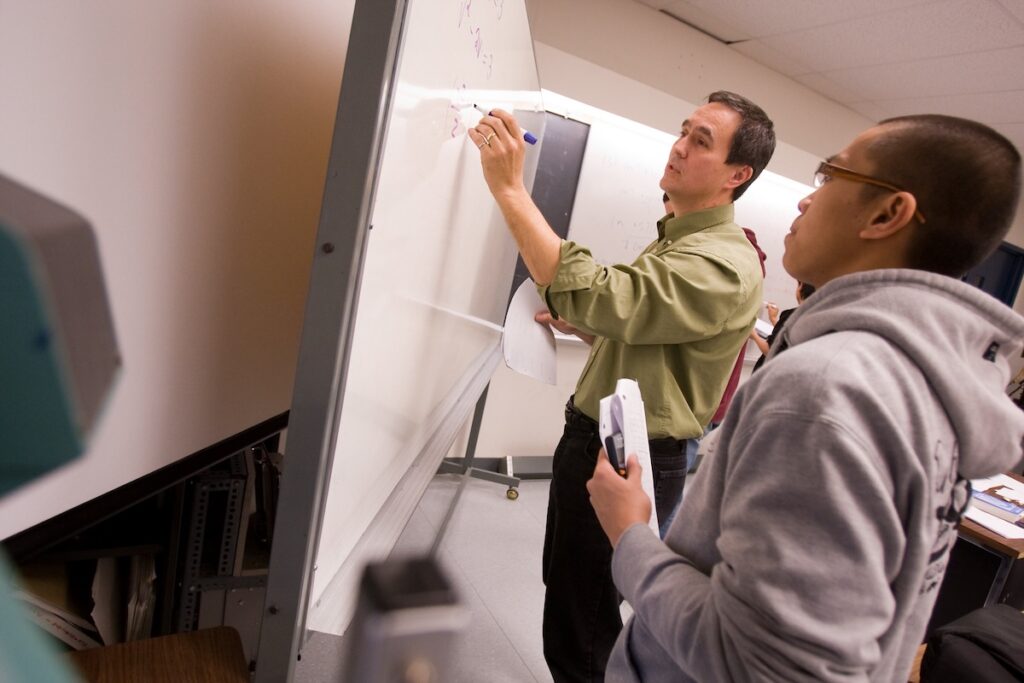 Instructor explains technical concepts to students during a classroom learning session.