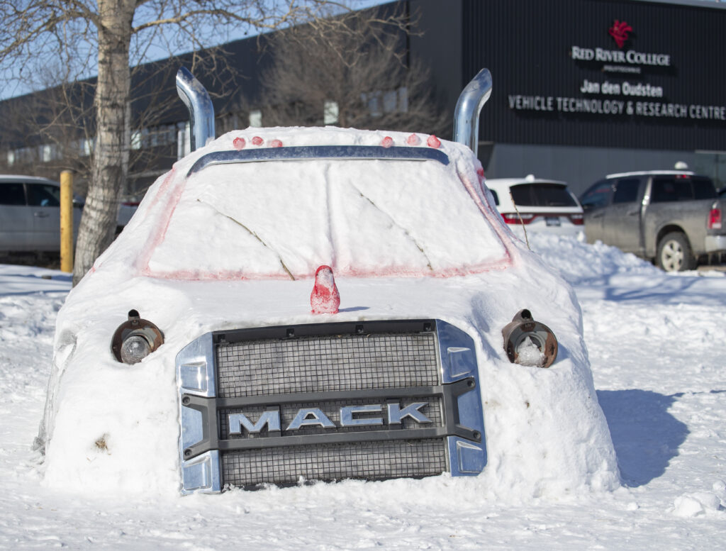 A snow sculpture of a MACK brand truck.