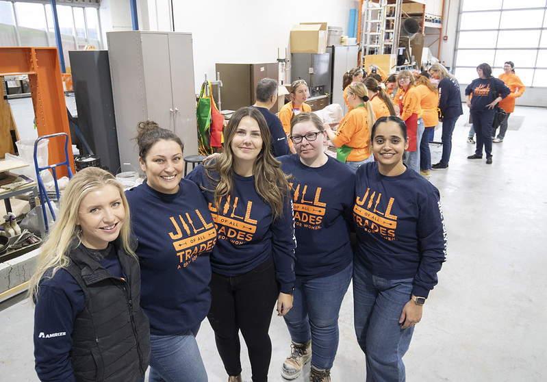 Five people stand and smile at the camera.
