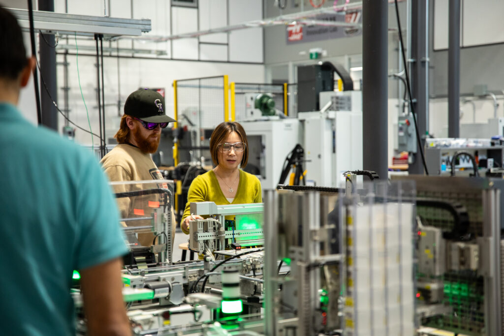 An instructor and students in a lab.