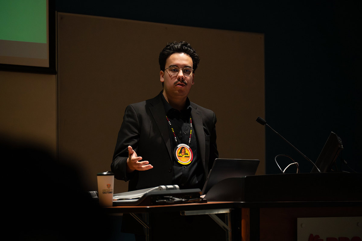 Person speaking at the front of a classroom