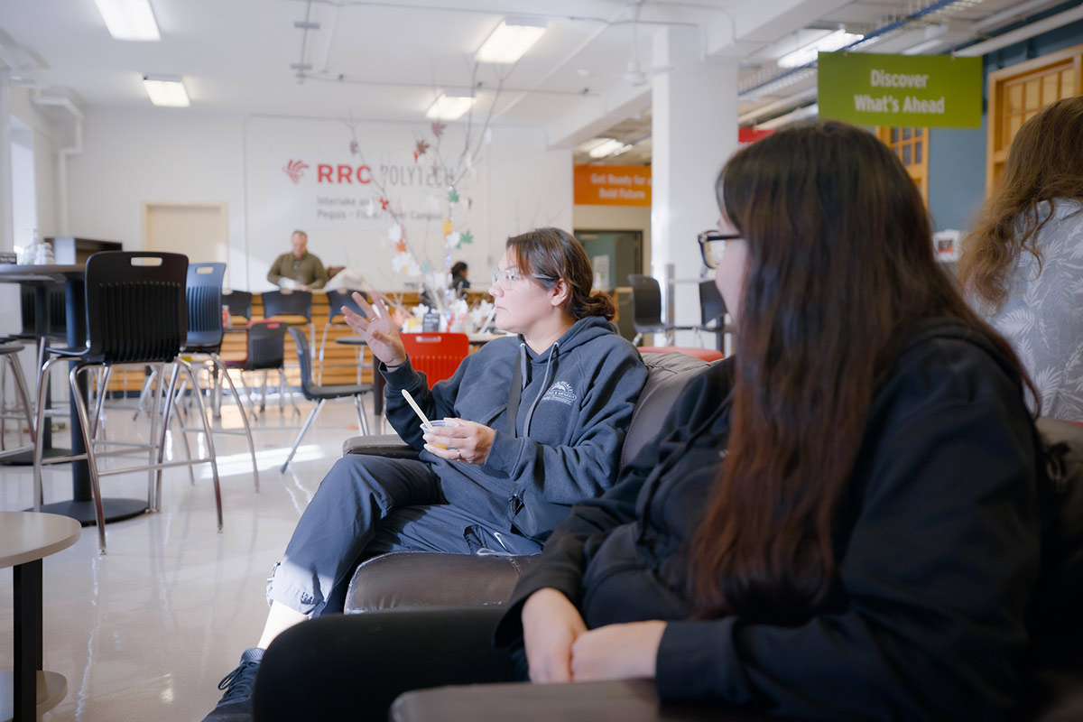 Students sitting on a couch and talking