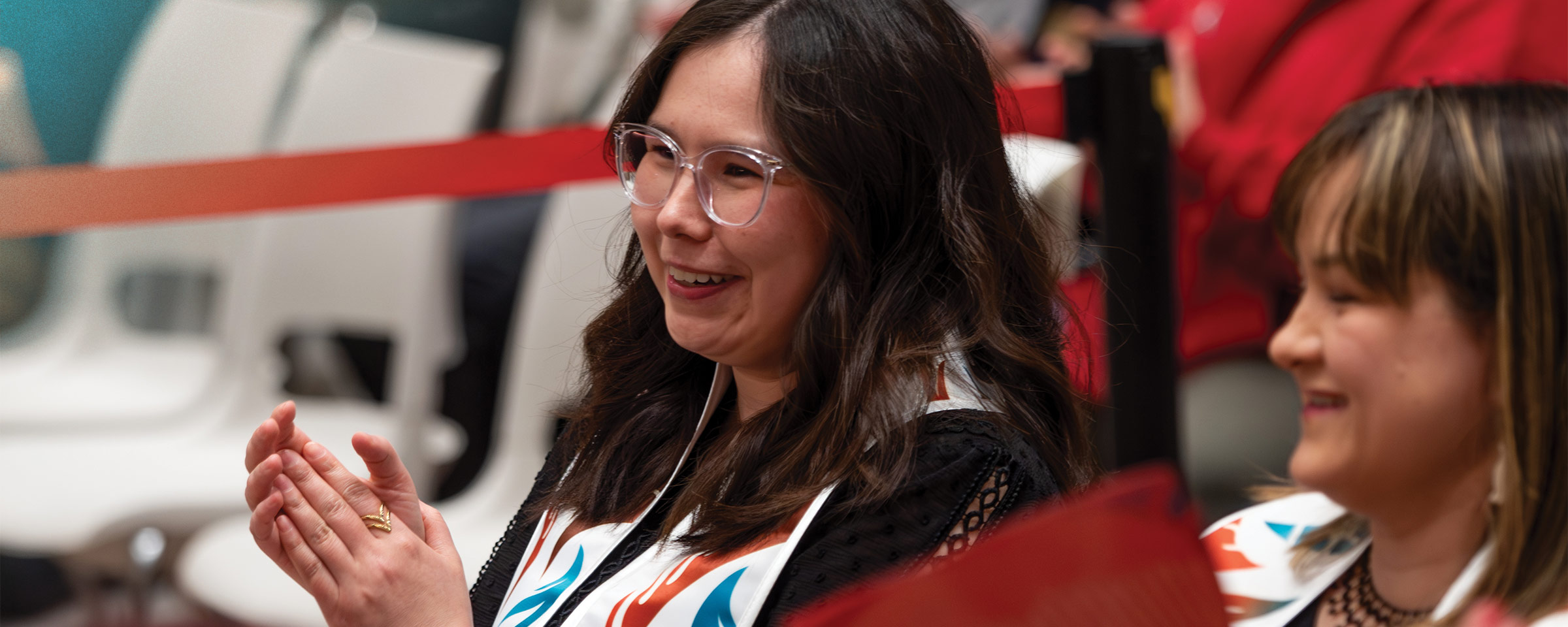 Smiling Indigenous graduate at convocation ceremony