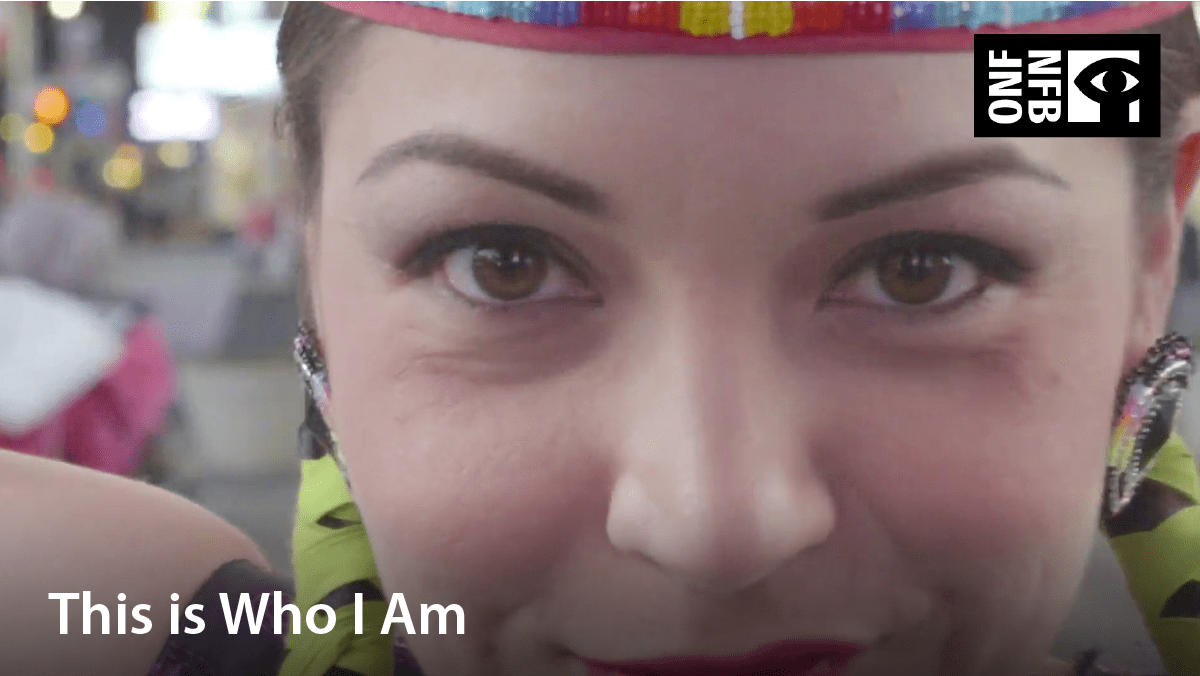 Indigenous girl dressed in dancing attire. Film title: This is who I am