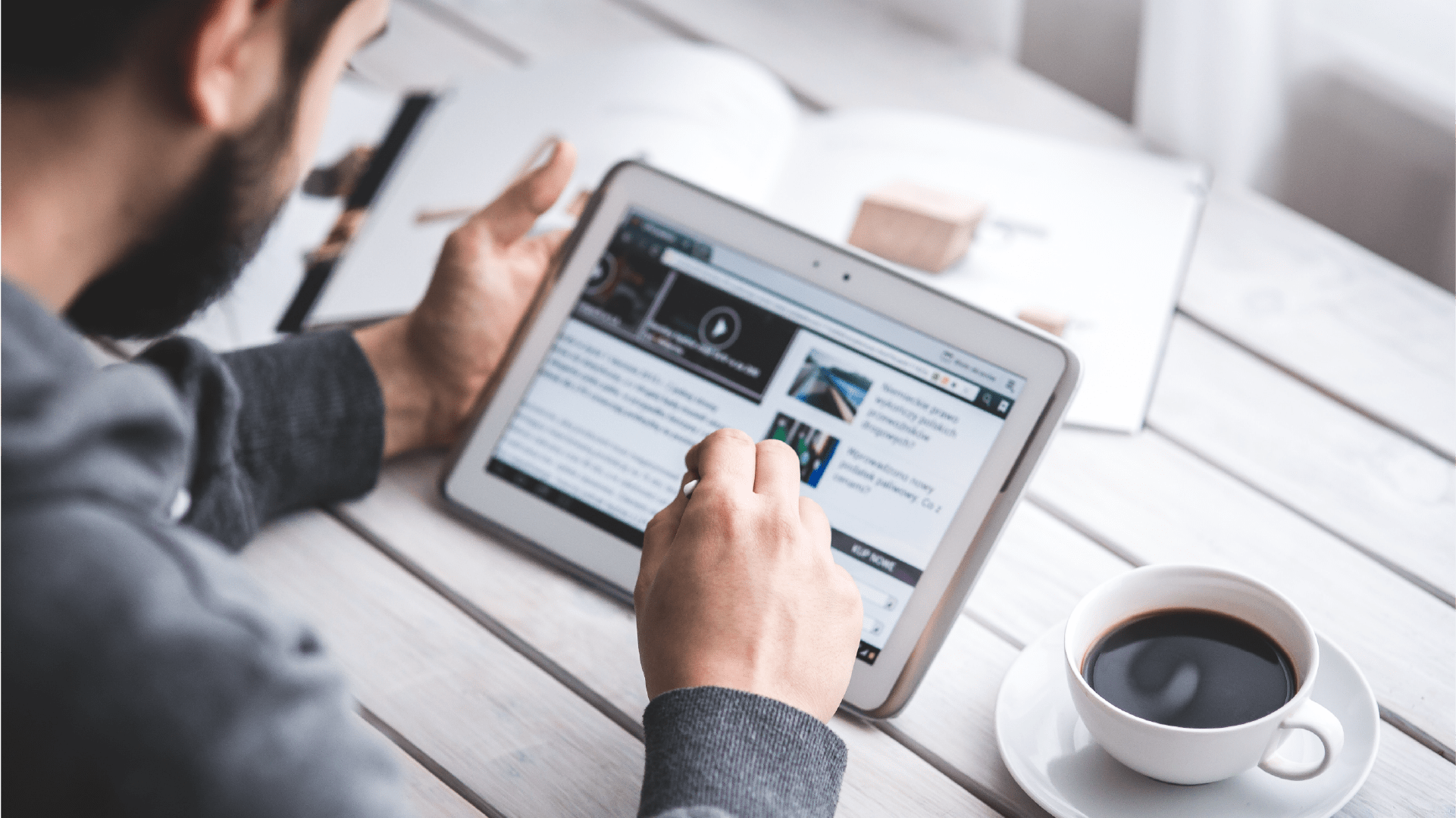 Person reading news on an electronic device.