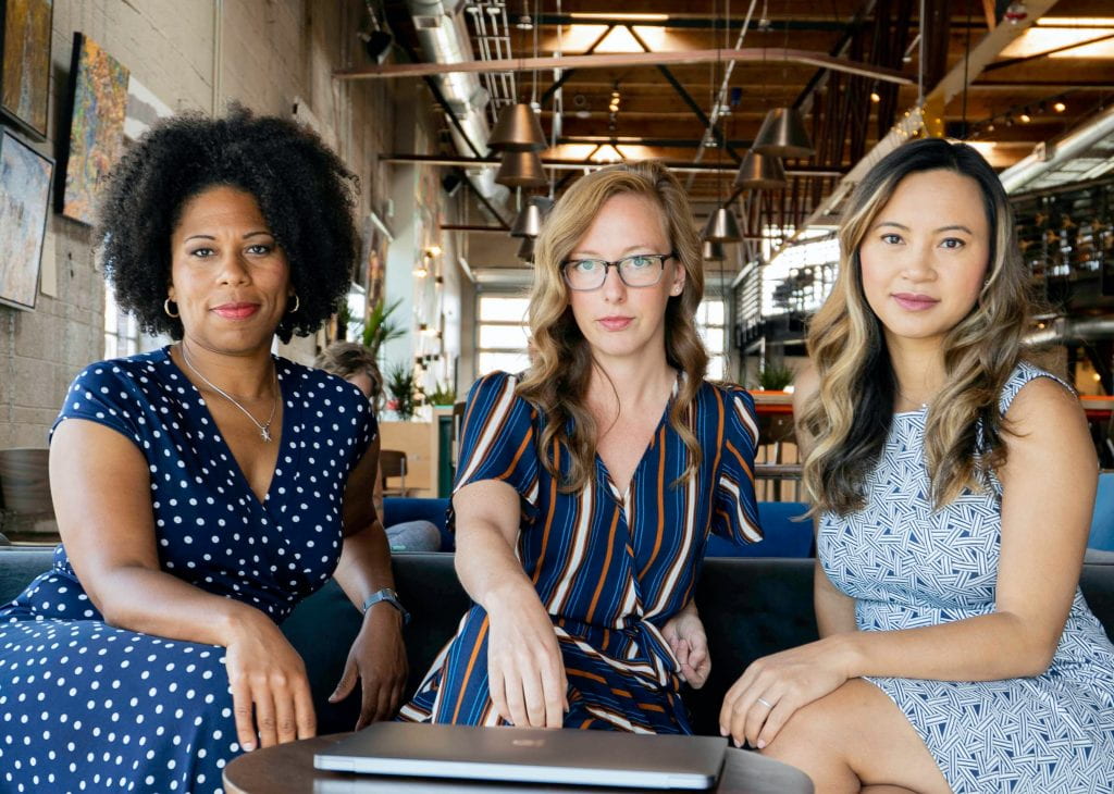 3 women sitting on a chair