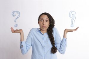 Person with question marks in hands
