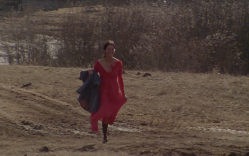 screenshot of the NFB film, showing an indigenous woman in a red dress