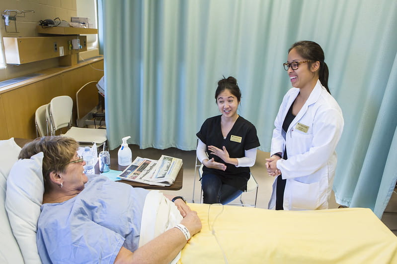 Health care professionals at patient bedside