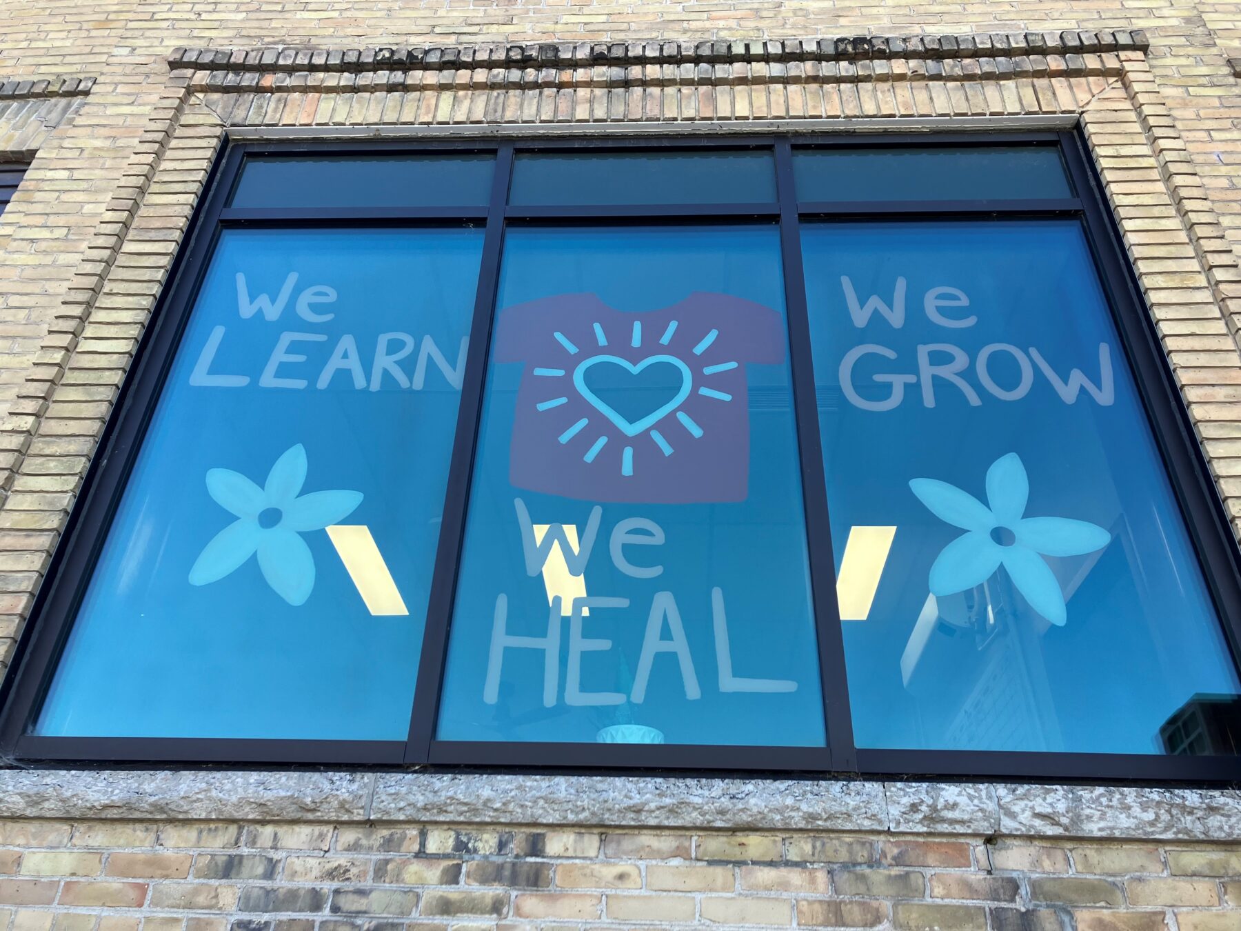 window display at the Portage Campus with the words "We Learn. We Grow. We Heal"