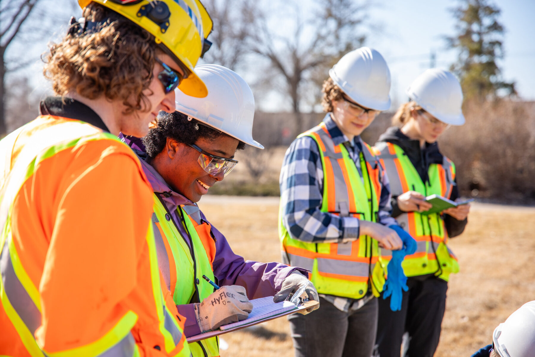 a group of environmental engineering technology students in PPE working together outside at the Notre Dame Campus