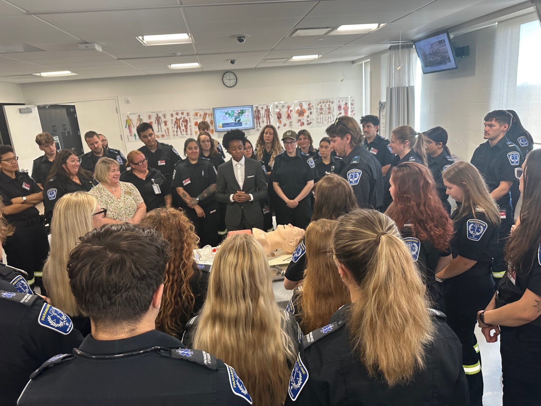 Nearly 70 ACP and PCP students gather around a demonstration by a ACP student for Minister Asagwara