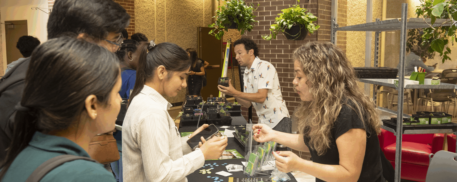 Students interacting with others and looking at succulents