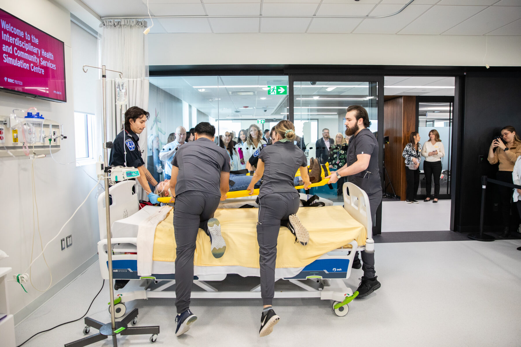 a group of healthcare students training on a patient in a hospital gurney