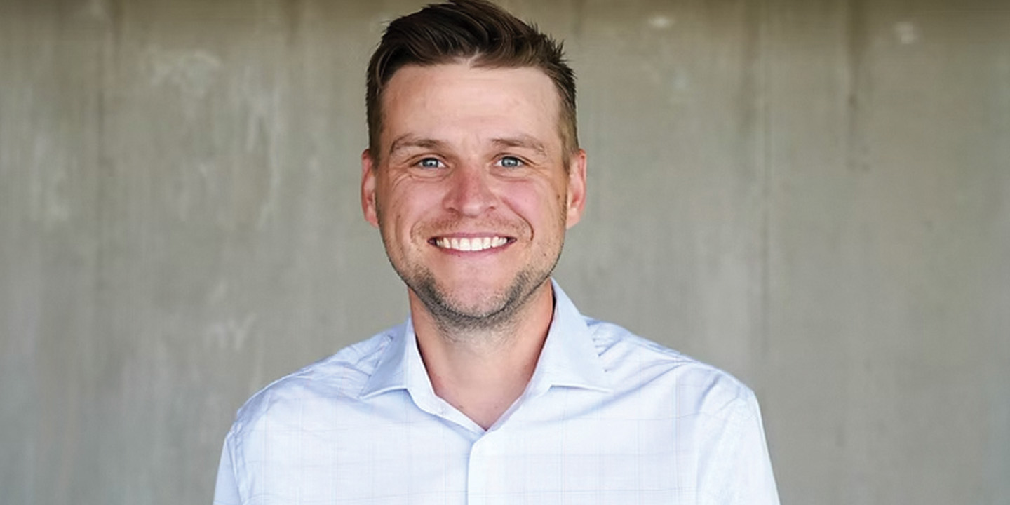 A man is looking at the camera and smiling