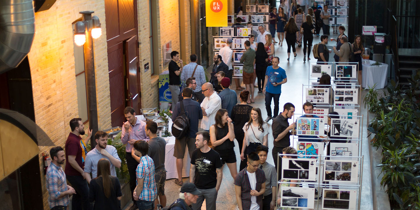 People look at displays of art in the hallway of RRC Polytech.