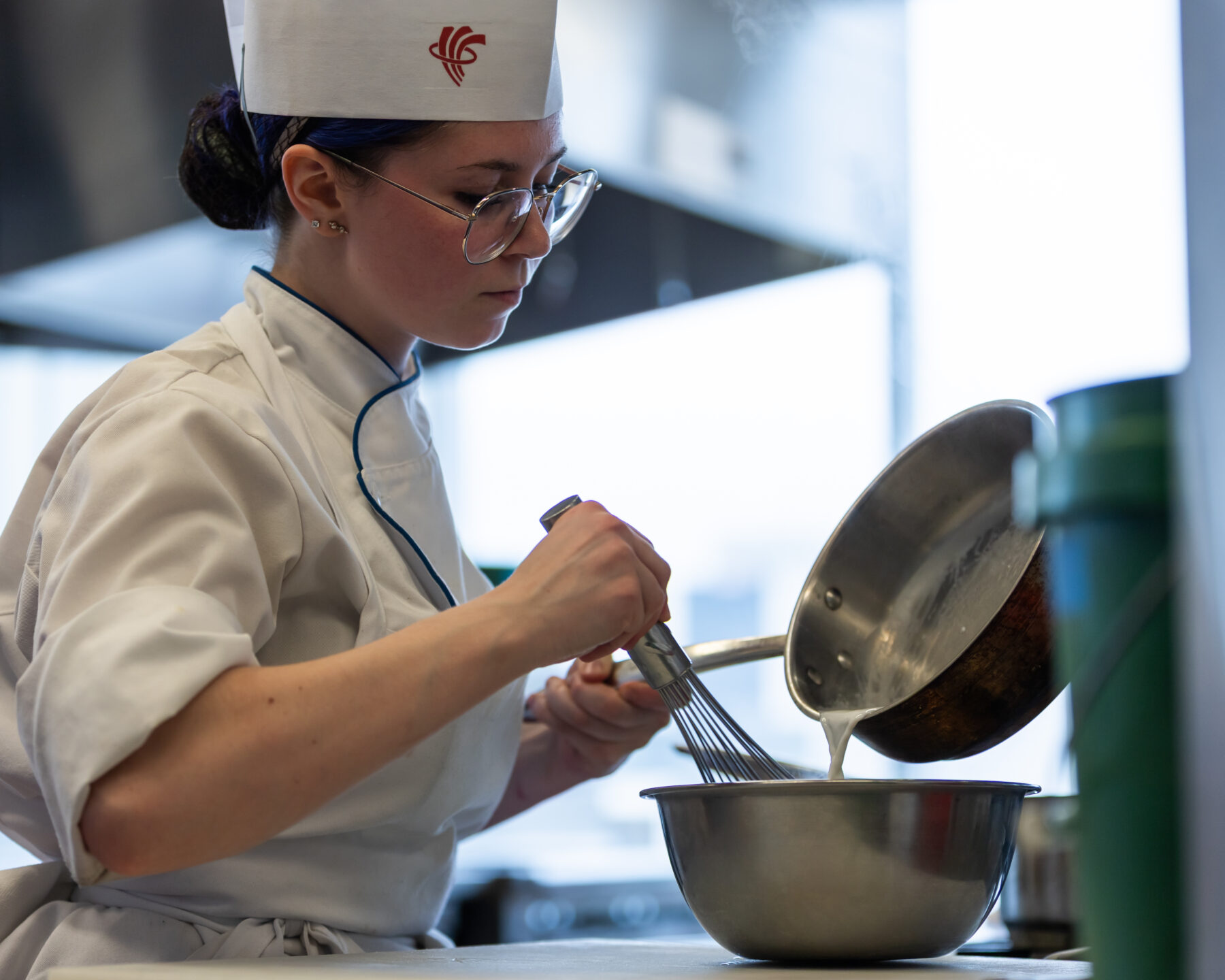 a chef whisking a bowl of ingredients