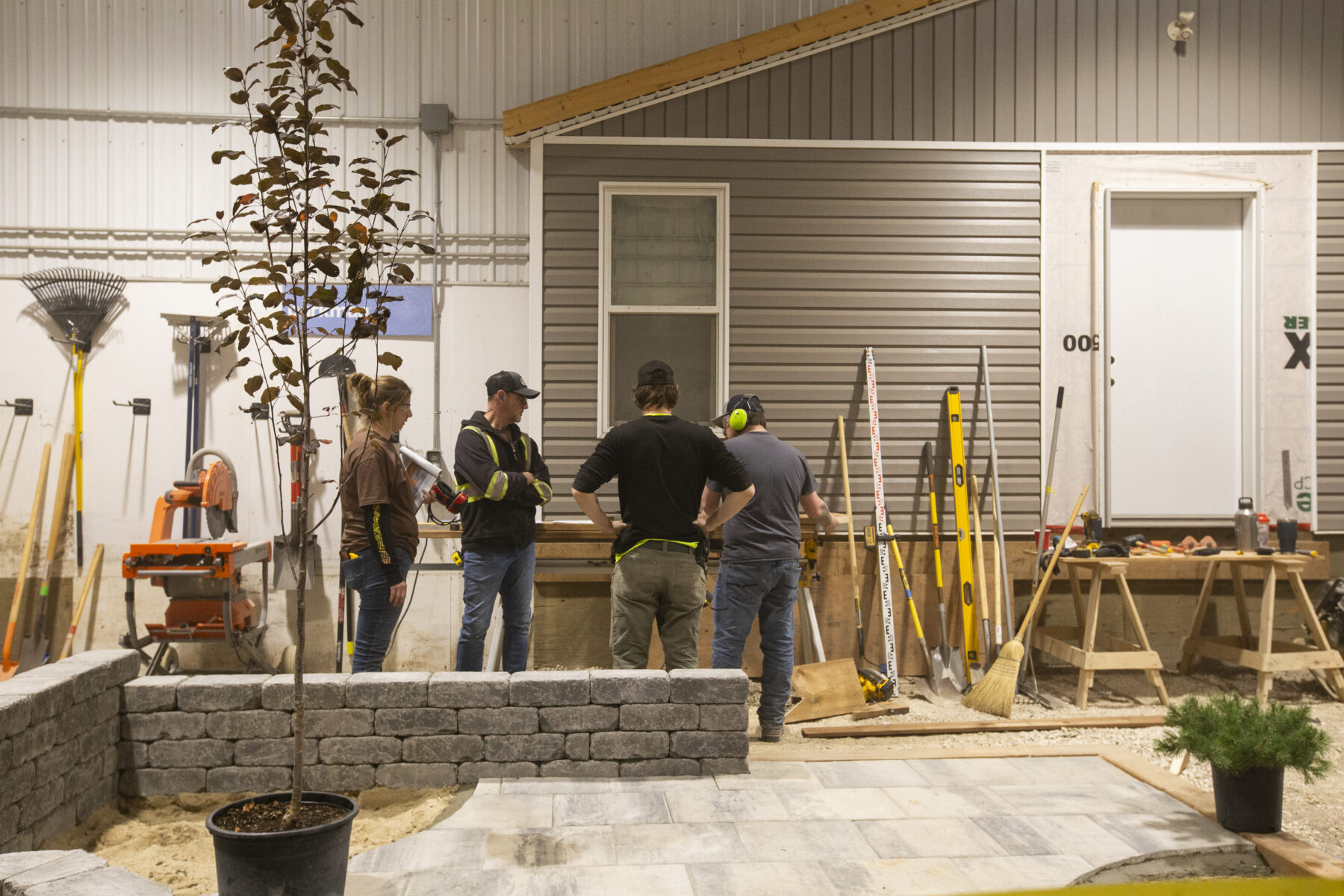 a group of tradespeople talking in the landscaping lab
