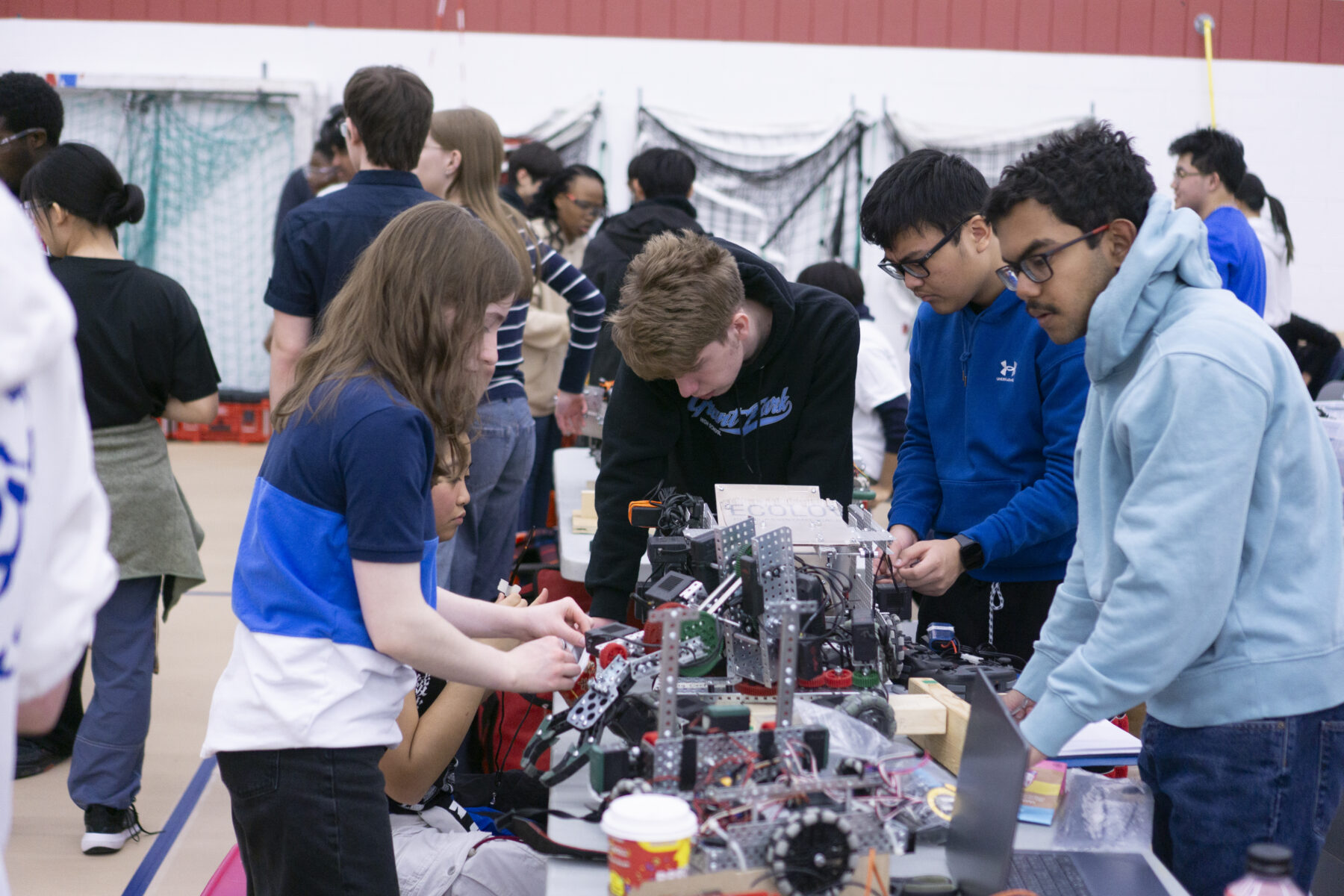 a group of students assembling a robotic model