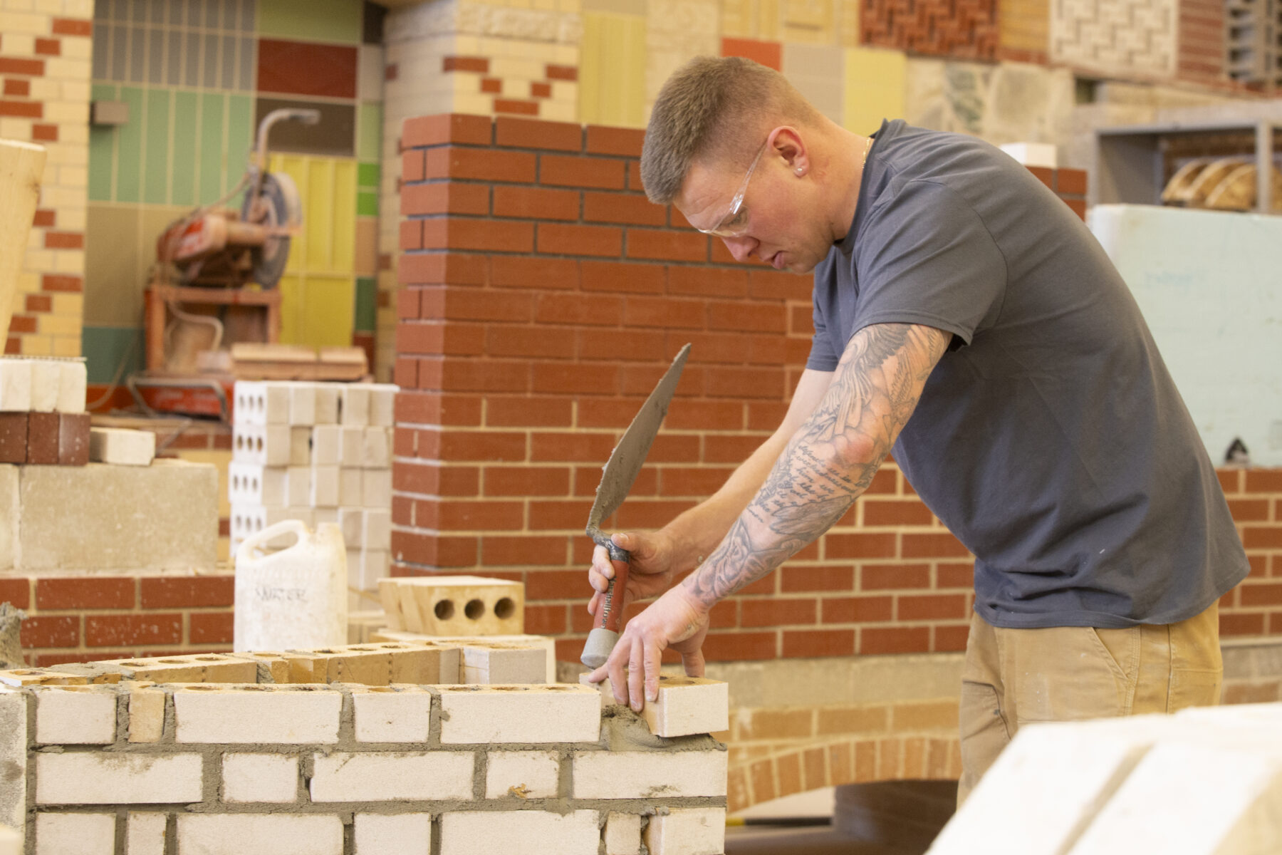 a person adds mortar to a brick wall