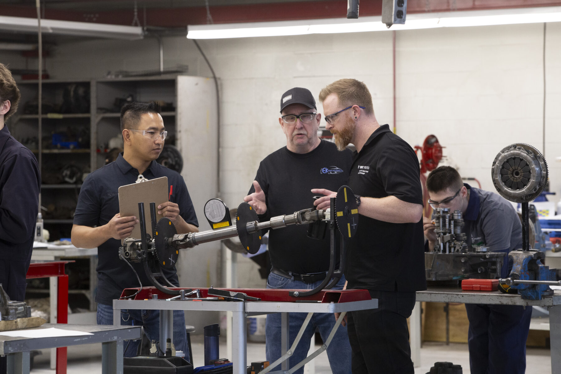a group of instructors judge an auto tech task