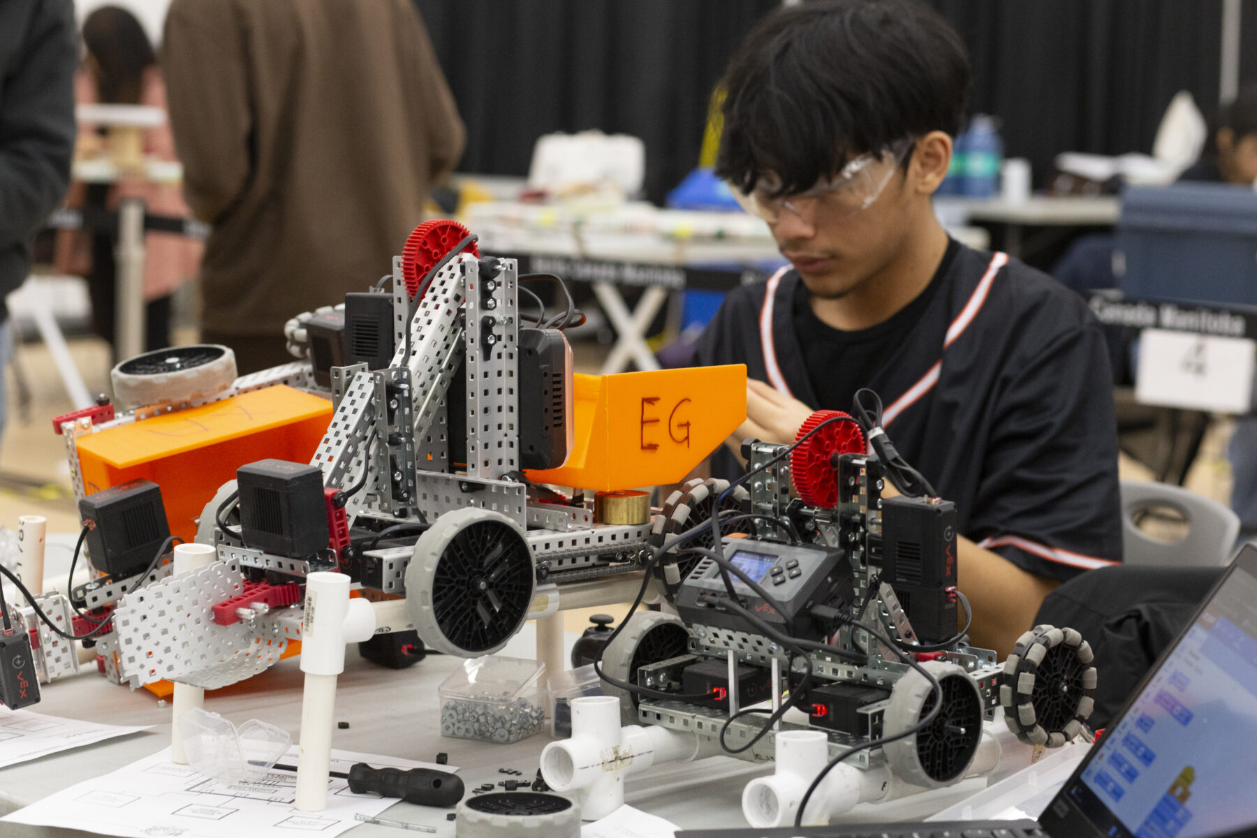 a person assembles a robotic model
