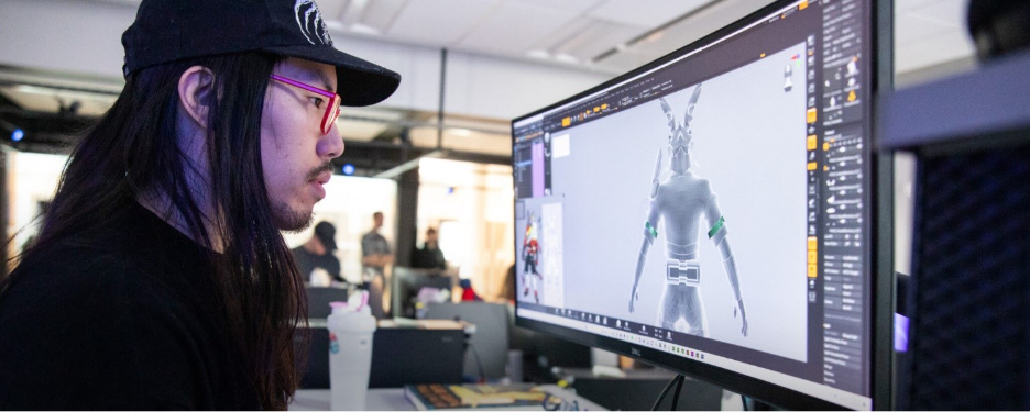 A student looks at a computer screen with an animation on it.