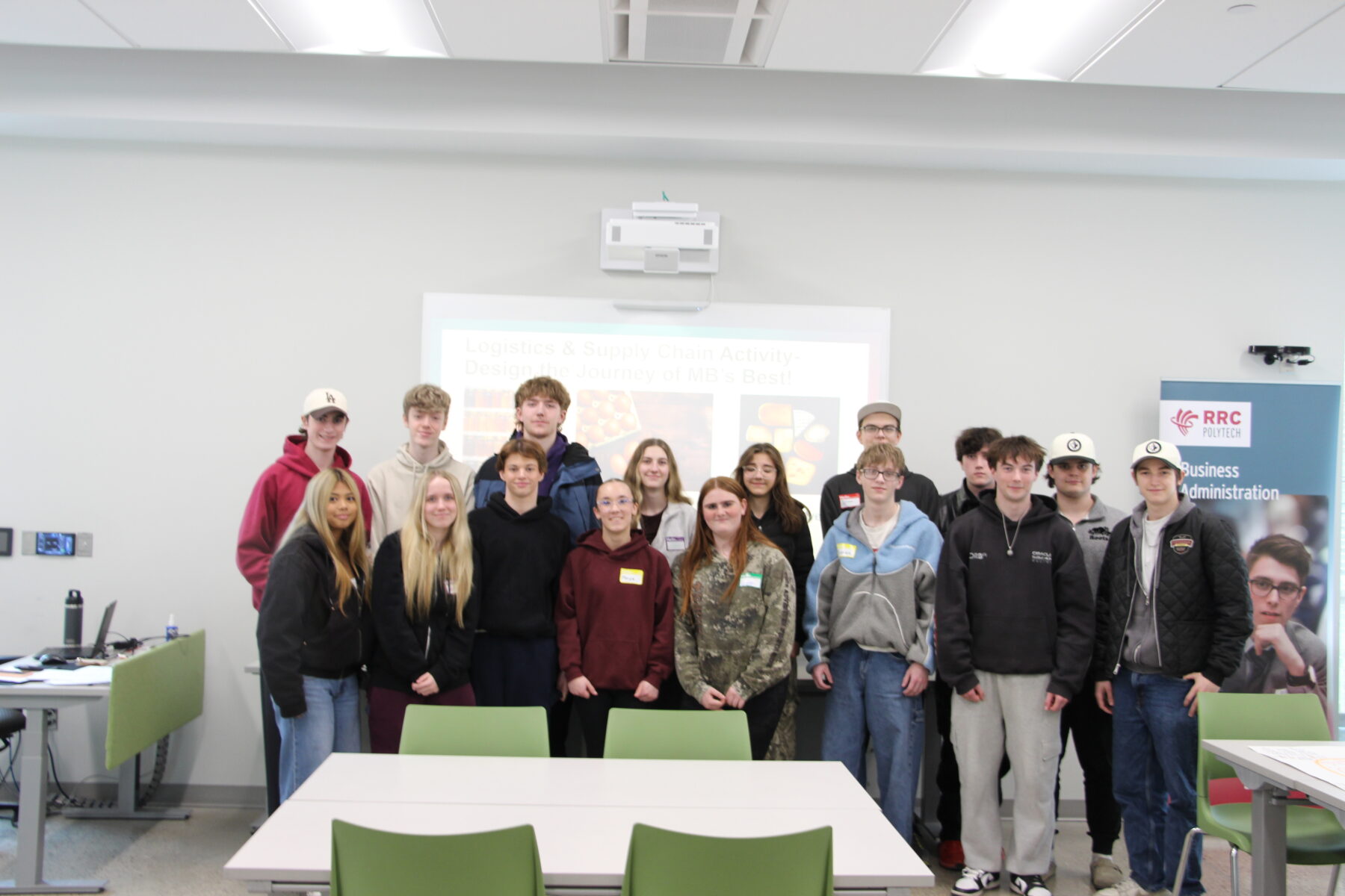Group of students posing for a photo in a classroom