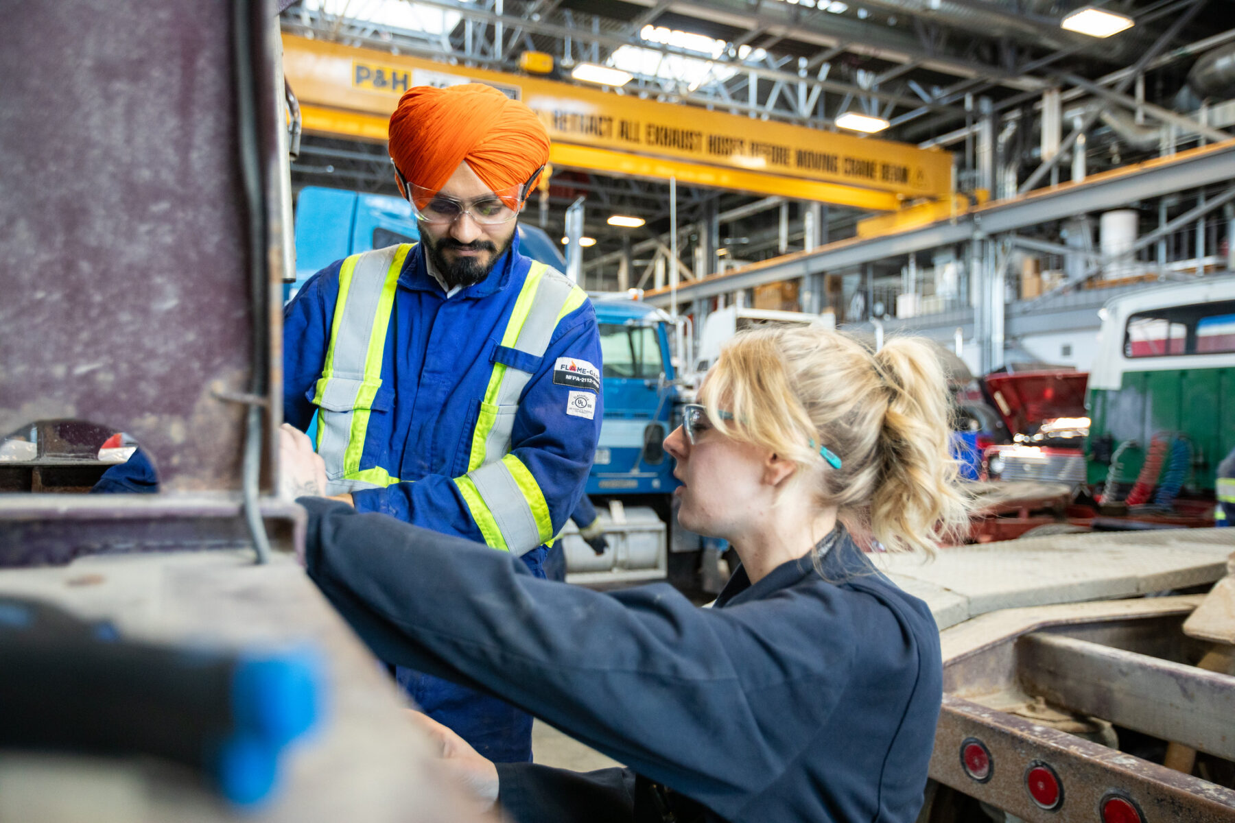 Instructor in the Heavy Duty Equipment shop leads a demonstration with a student.
