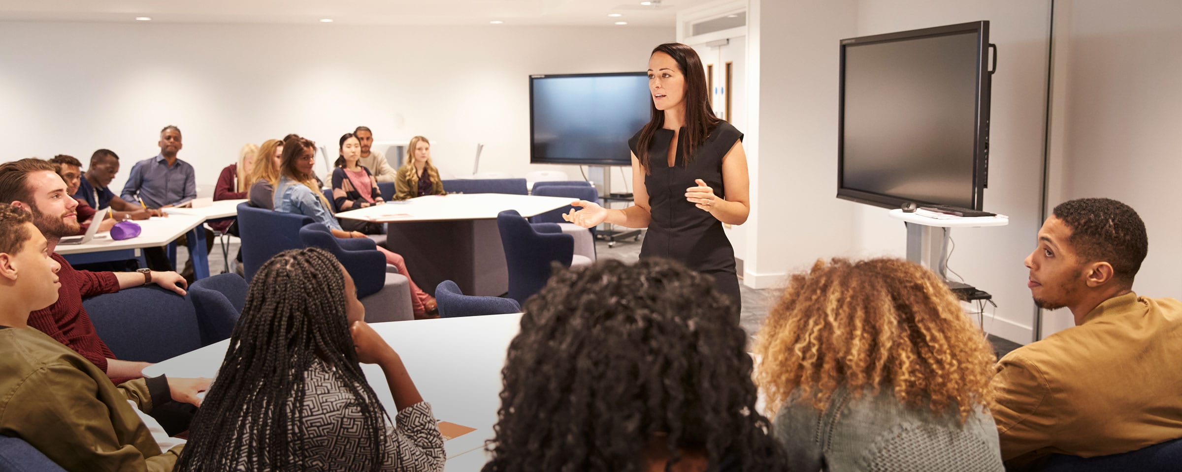 Woman speaking to a room full of people