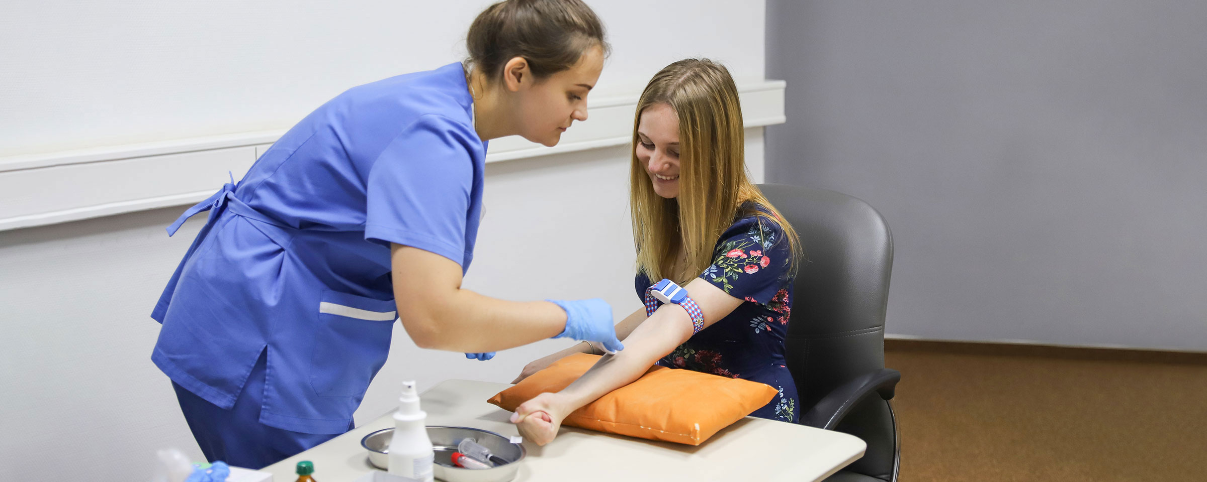 Nurse drawing blood from patient