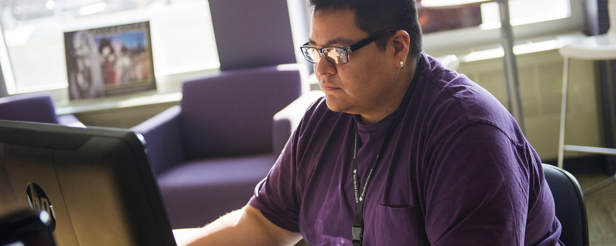 Indigenous student working on a computer