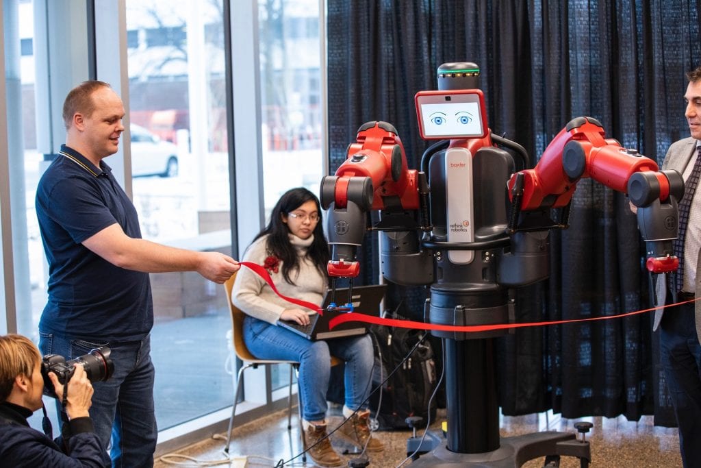 Bacter the Robot cutting STTC ribbon