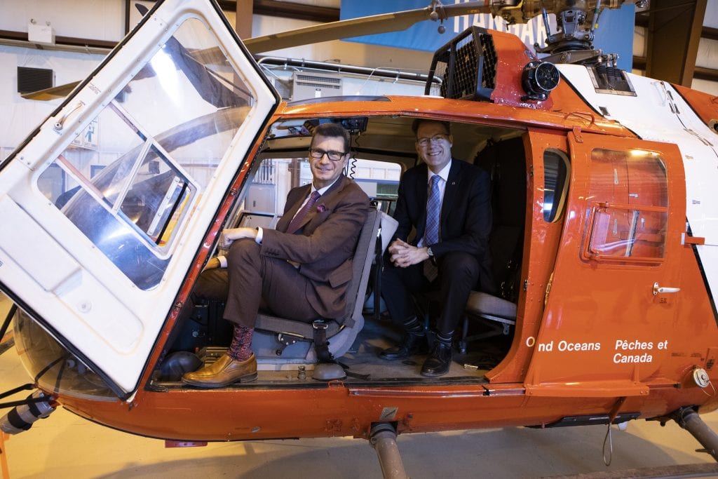 MP Doug Eyolfson and RRC Polytech President Paul Vogt, inside Coast guard helicopter