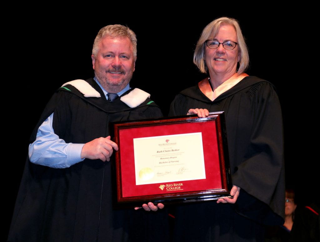 RRC Polytech president Darin Brecht presenting honorary degree to Dr. Ruth Betker