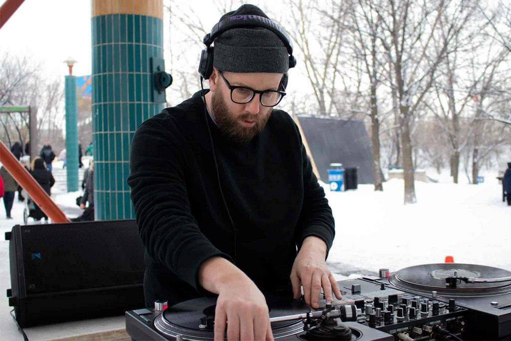 Tyler Sneesby (aka DJ Hunnicutt) spinning records at The Forks