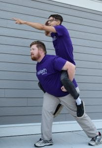 Man carrying second man on his back