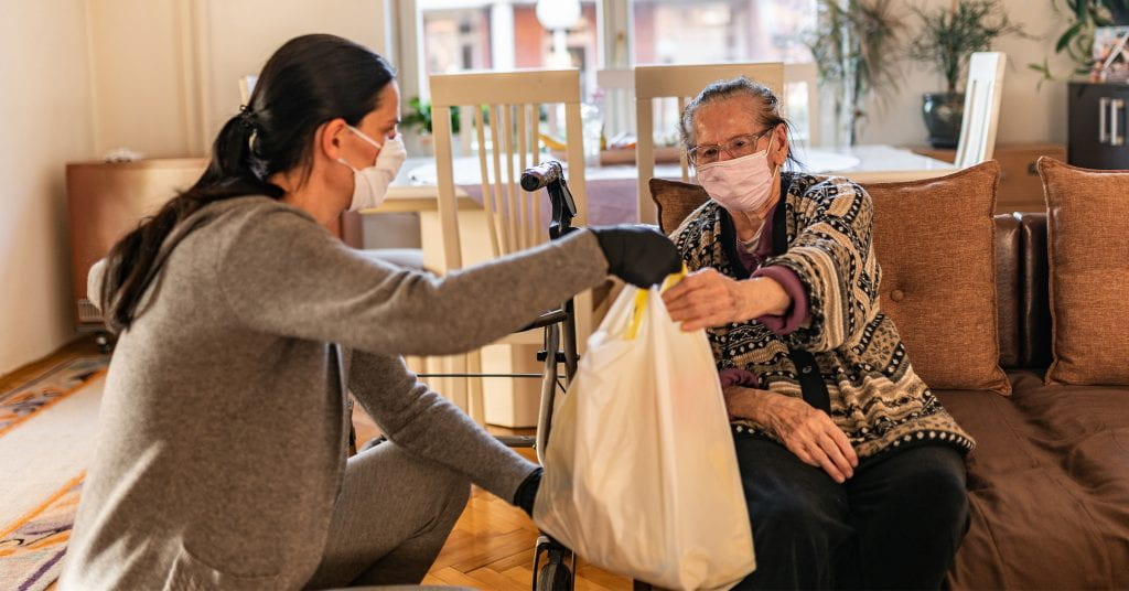 Direct service provider assists elderly woman