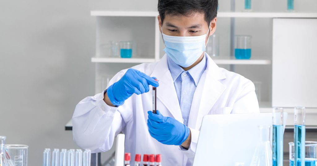 Lab worker examining blood sample