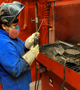 Monique Moneas with welding equipment