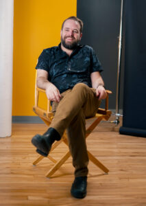 Doug Darling, seated in director's chair