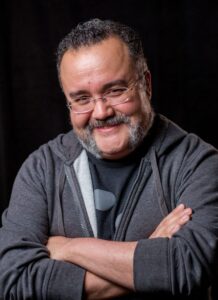 Lucasfilm's Pablo Hidalgo, smiling with arms folded