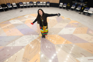 Artist KC Adams showcases Morning Star installation in floor of RRC Polytech's Roundhouse Auditorium
