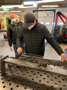 RRC Polytech Welding student taking measurements in skilled trades lab