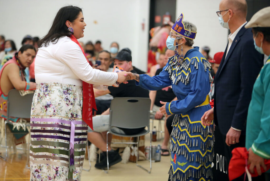 Elder Miss Una Swan congratulates female graduate at RRC Polytech's Pow Wow 2022