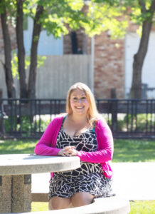 RRC Polytech grad Amanda Jack, seated at bench in park