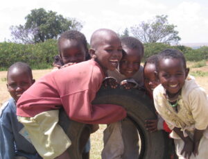 Group of boys playing with tire in Kenya