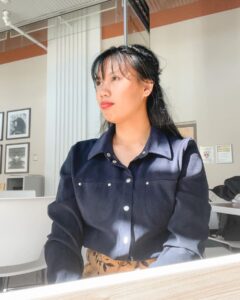 Photo portrait of Pauline Tayag sitting a desk