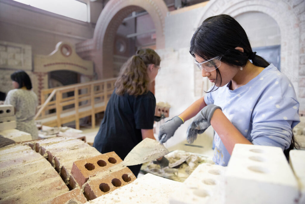 Two pre-teen girls working in RRC Polytech's bricklaying lab